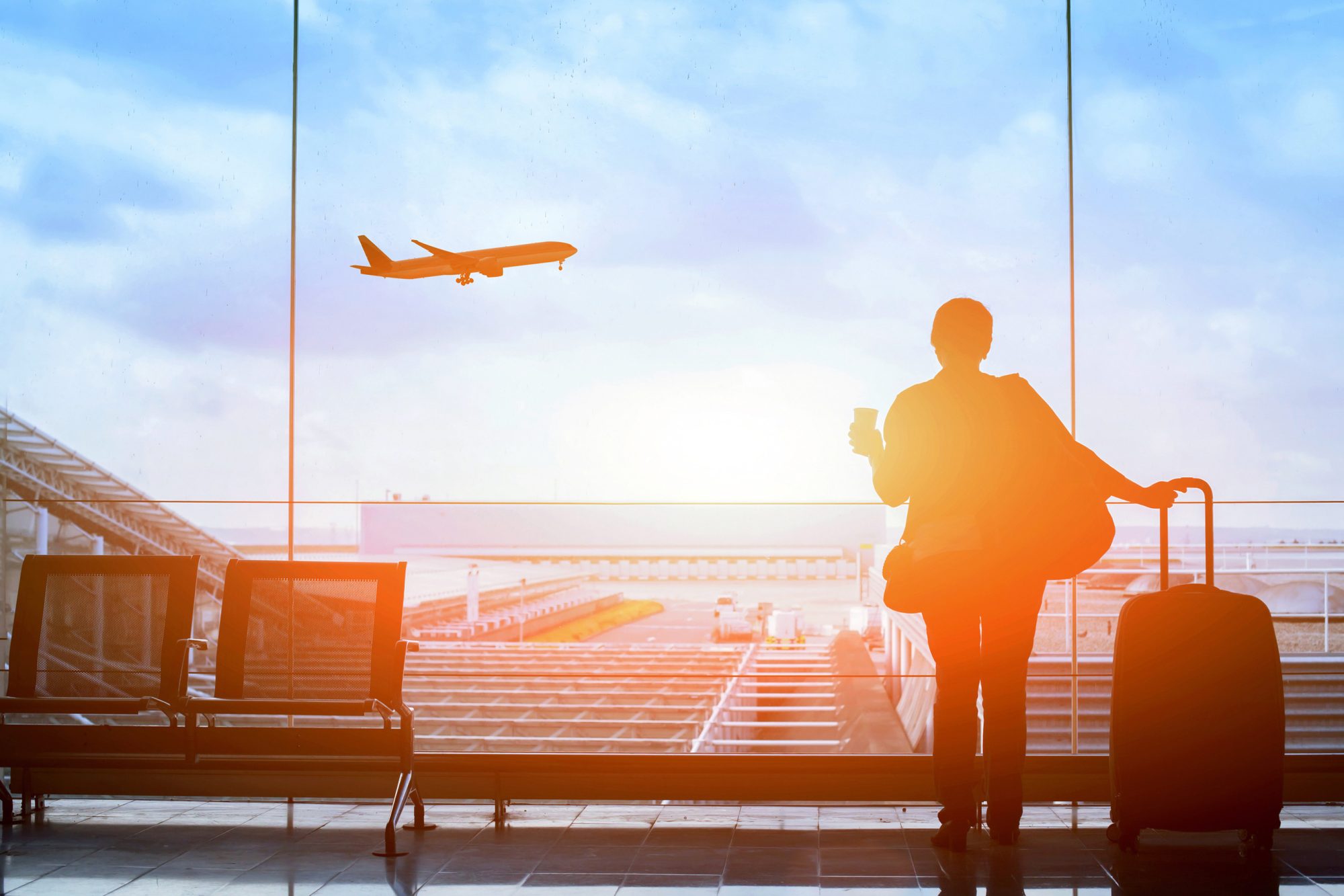 Passenger waiting for flight in airport, departure terminal